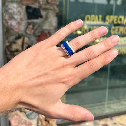 A sterling silver ring inlaid with a piece of lapis lazuli.  A small crack runs through the piece of lapis.