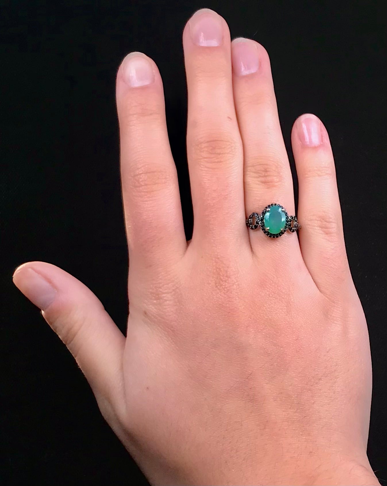 Dyed Ethiopian opal and black spinel prong set into a sterling silver ring.