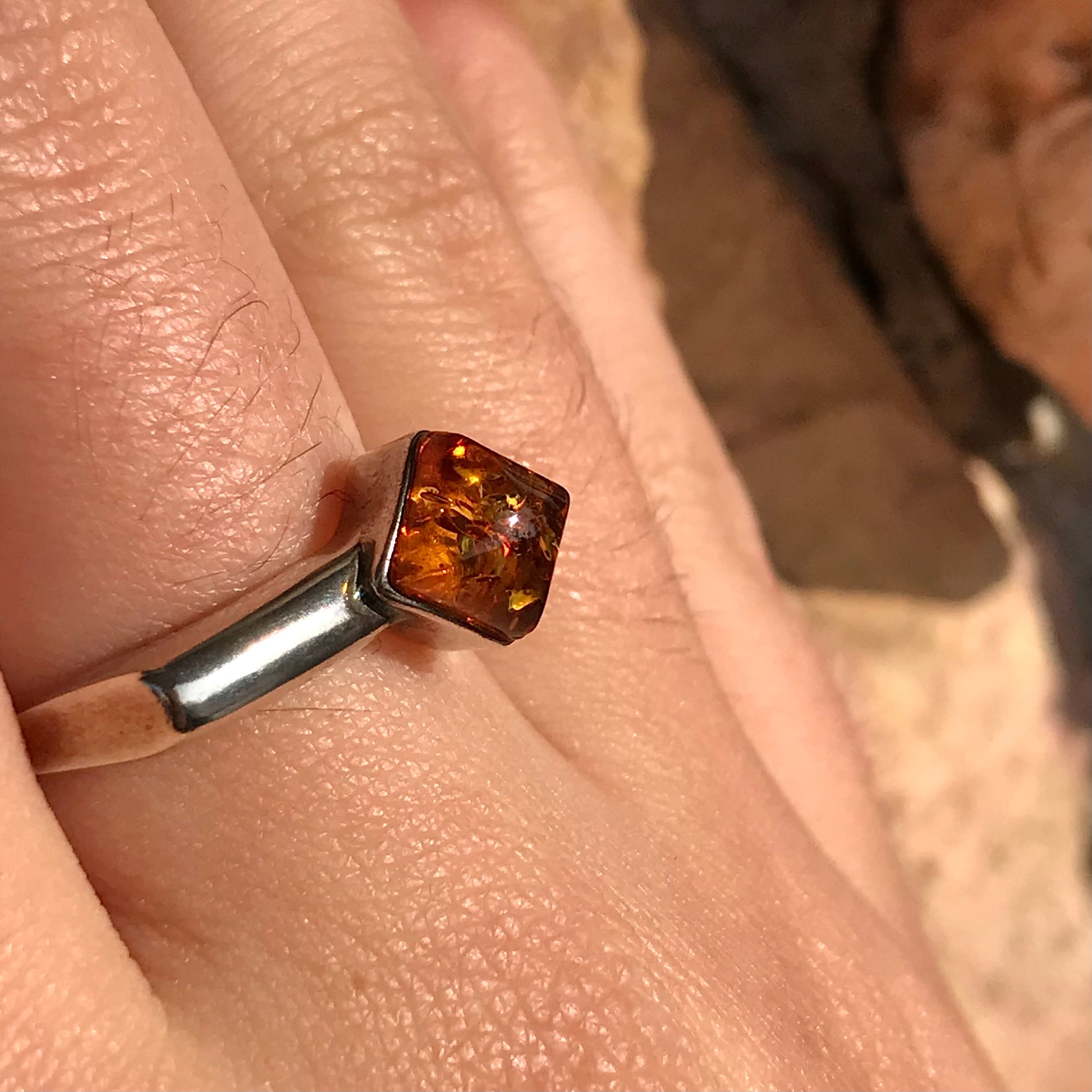 Square shaped Baltic Amber cabochon set in a unique sterling silver ring.