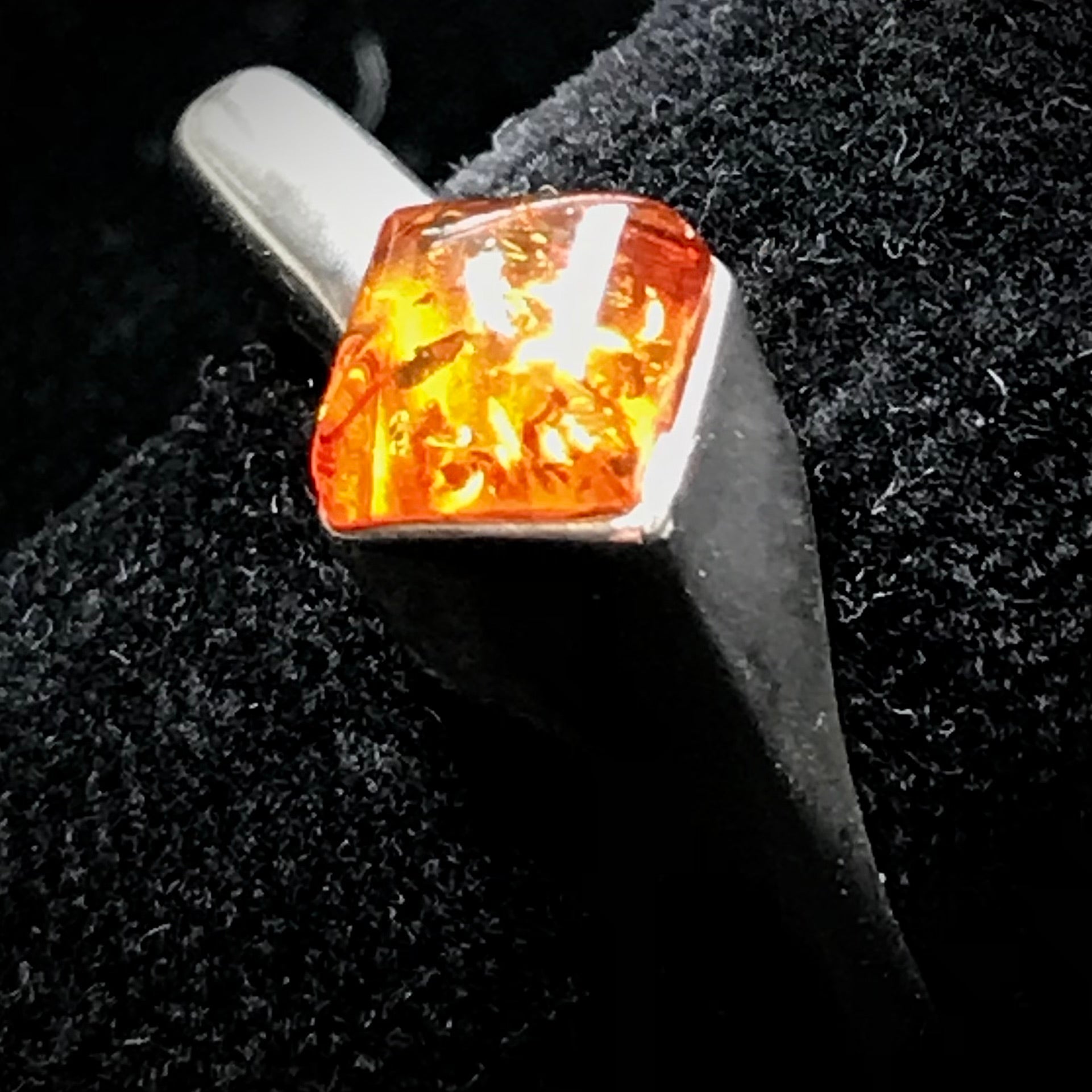 Square shaped Baltic Amber cabochon set in a unique sterling silver ring.