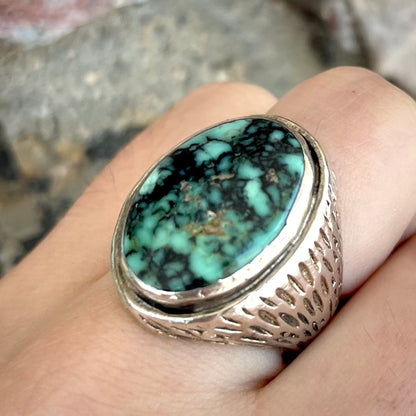 A sterling silver solitaire ring set with a black spiderweb turquoise stone from Kingman, Arizona.