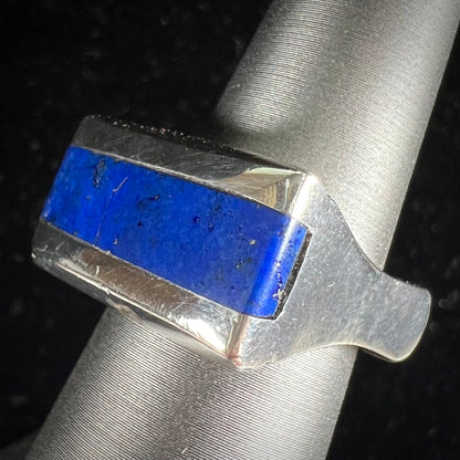 A sterling silver ring inlaid with a piece of lapis lazuli.  A small crack runs through the piece of lapis.