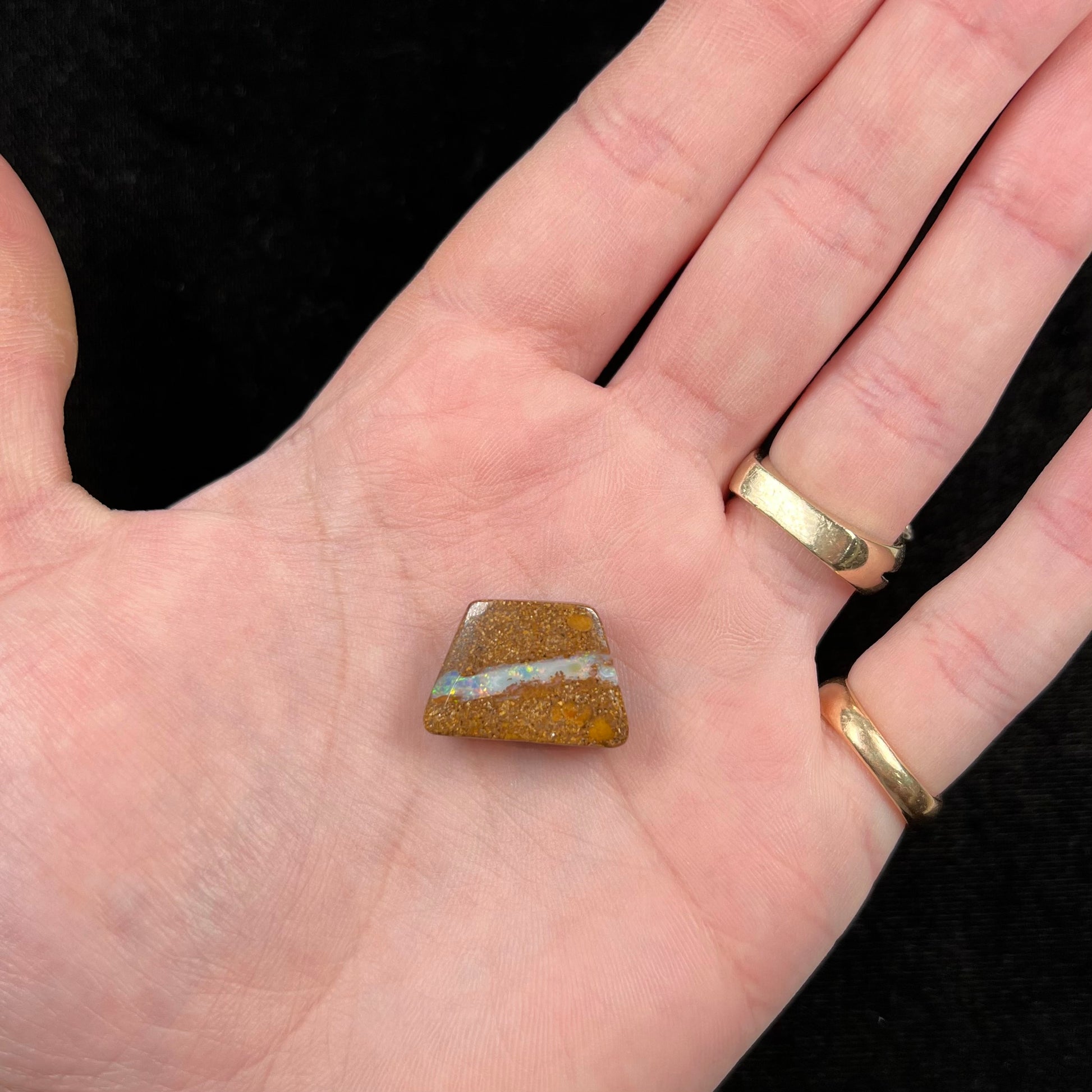 A polished, drilled pipe boulder opal bead.