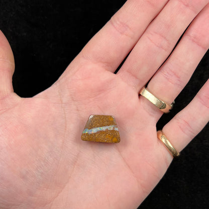 A polished, drilled pipe boulder opal bead.