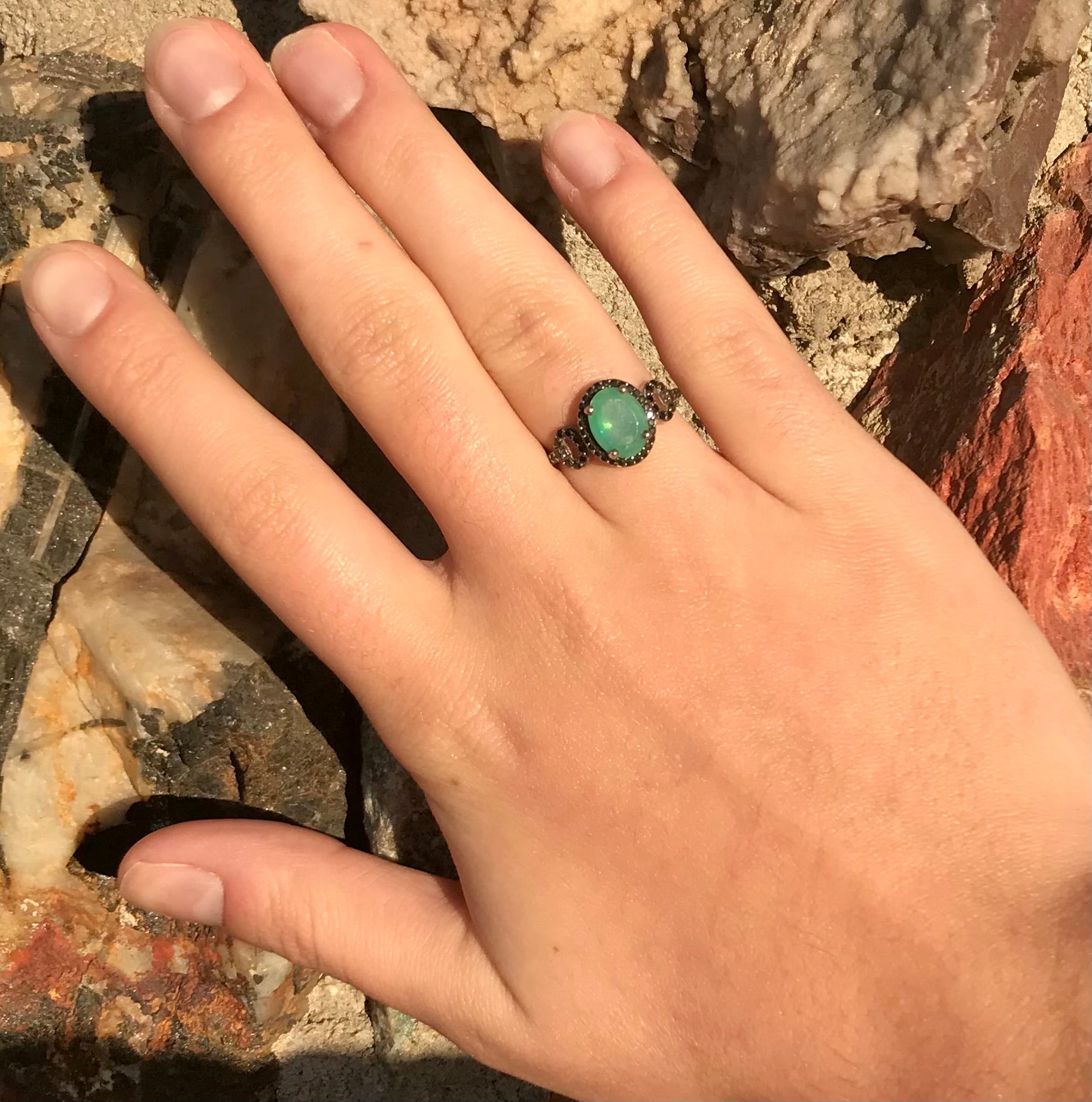 Dyed Ethiopian opal and black spinel prong set into a sterling silver ring.