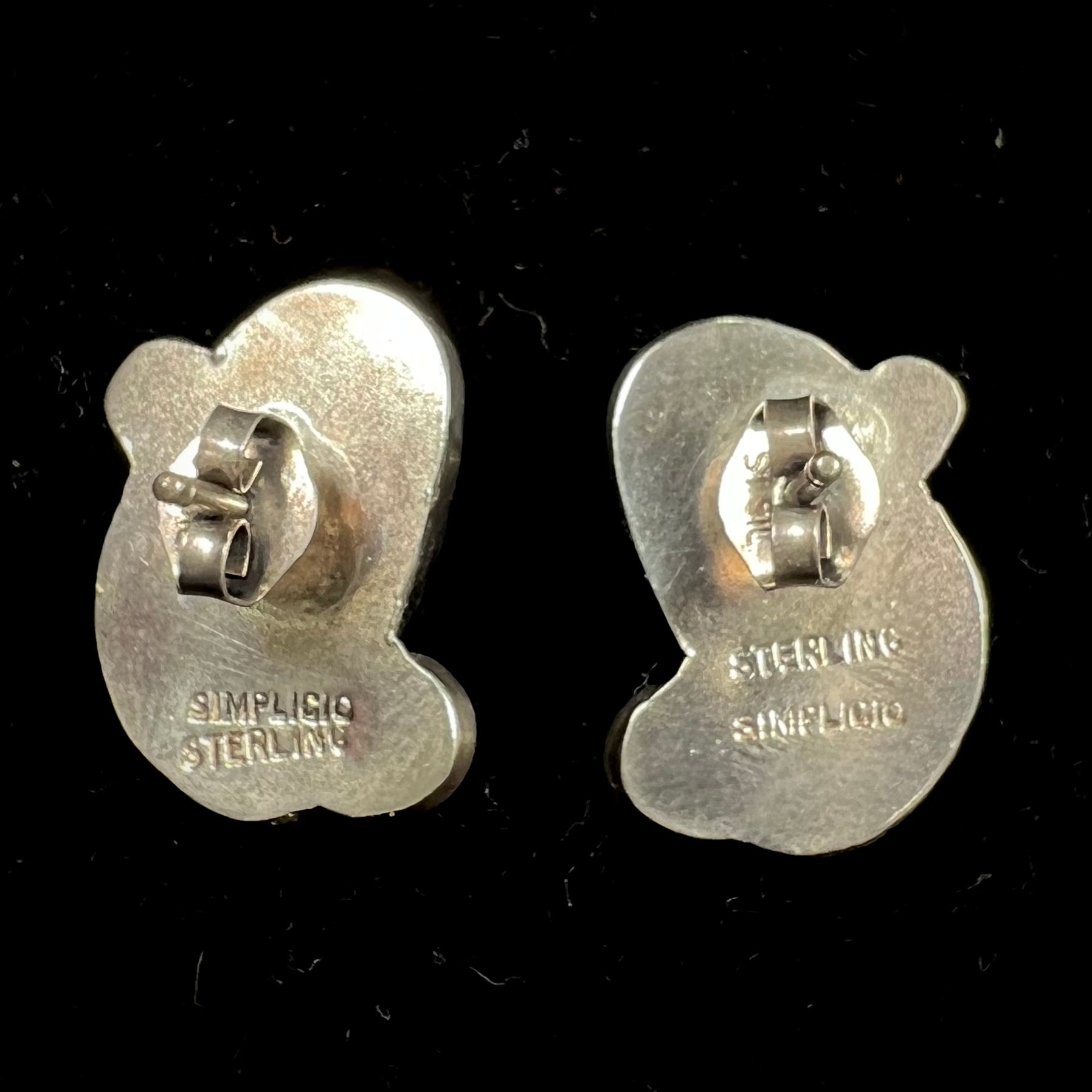 A pair of sterling silver coral earrings handmade by Zuni artists, Carmelita and Dan Simplicio.