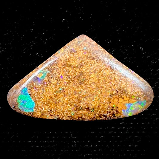 A polished, drilled pipe boulder opal bead.