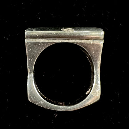 A sterling silver ring inlaid with a piece of lapis lazuli.  A small crack runs through the piece of lapis.