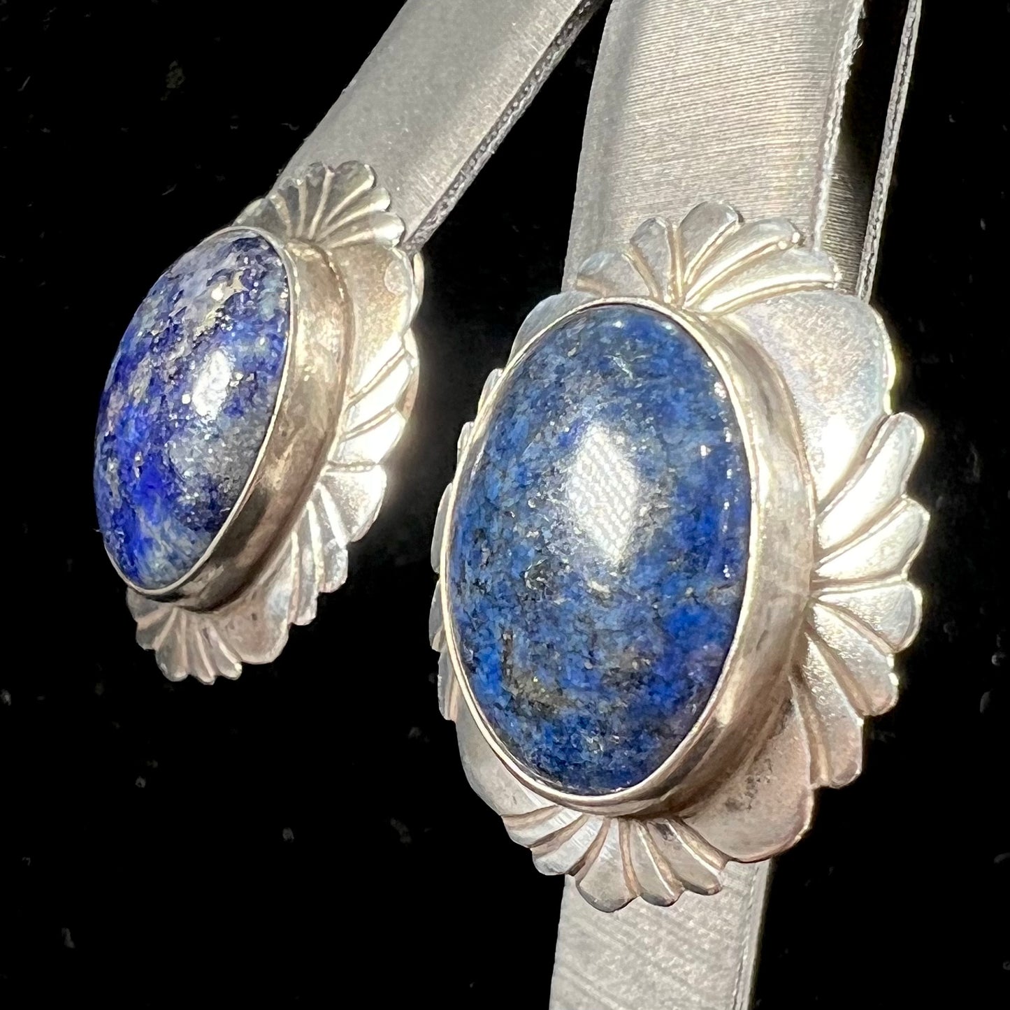 A pair of sterling silver lapis lazuli earrings handmade by Navajo artist, Filbert Brown.