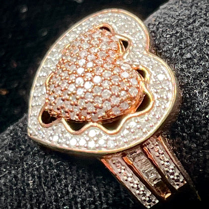 A rose colored metal ring pavé set with round and baguette cut diamonds.