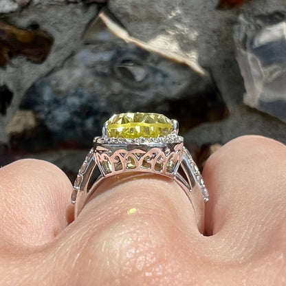 A pear shape lemon quartz set in a sterling silver and white topaz halo ring.