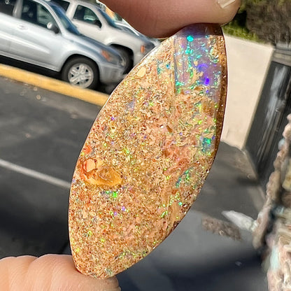 A polished, drilled pipe boulder opal bead.
