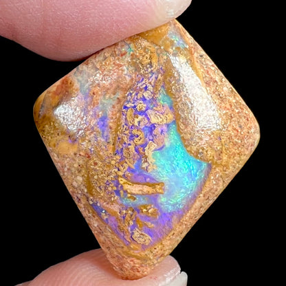 A polished, drilled pipe boulder opal bead.