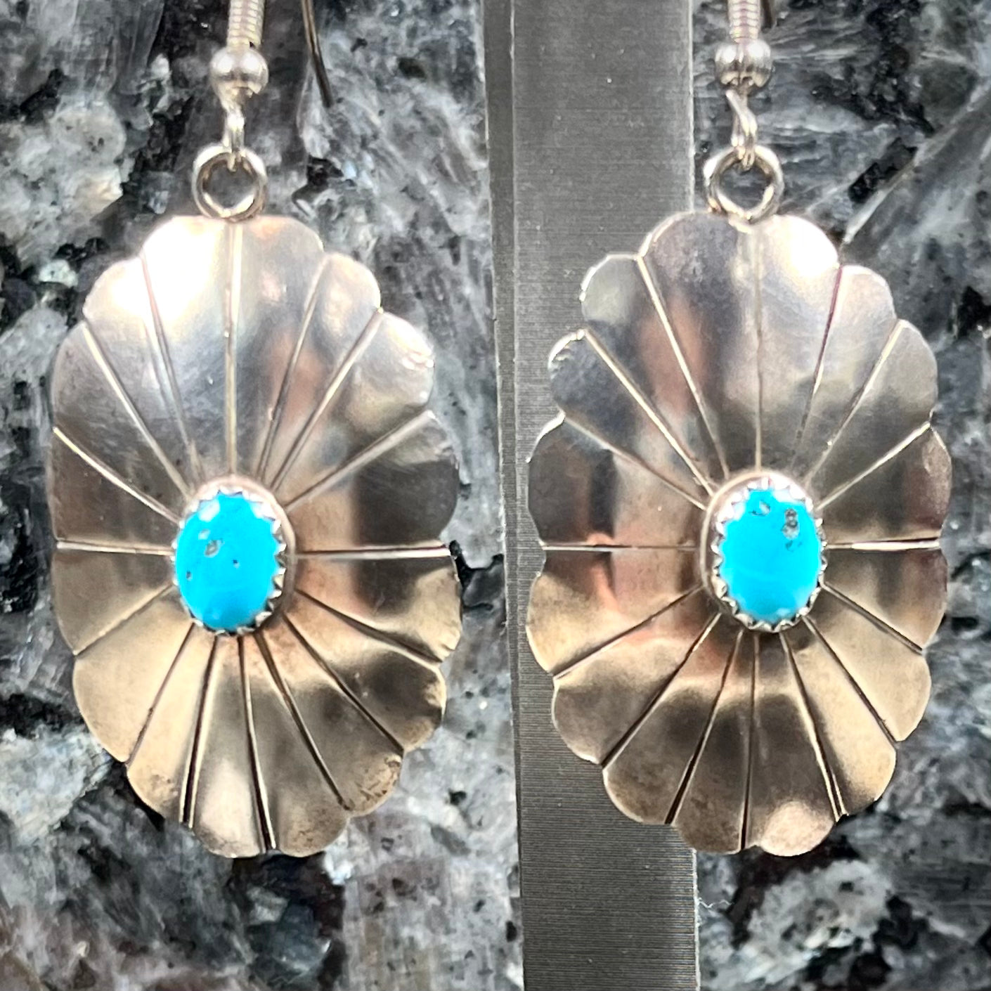 A pair of sterling silver concho turquoise dangle earrings.