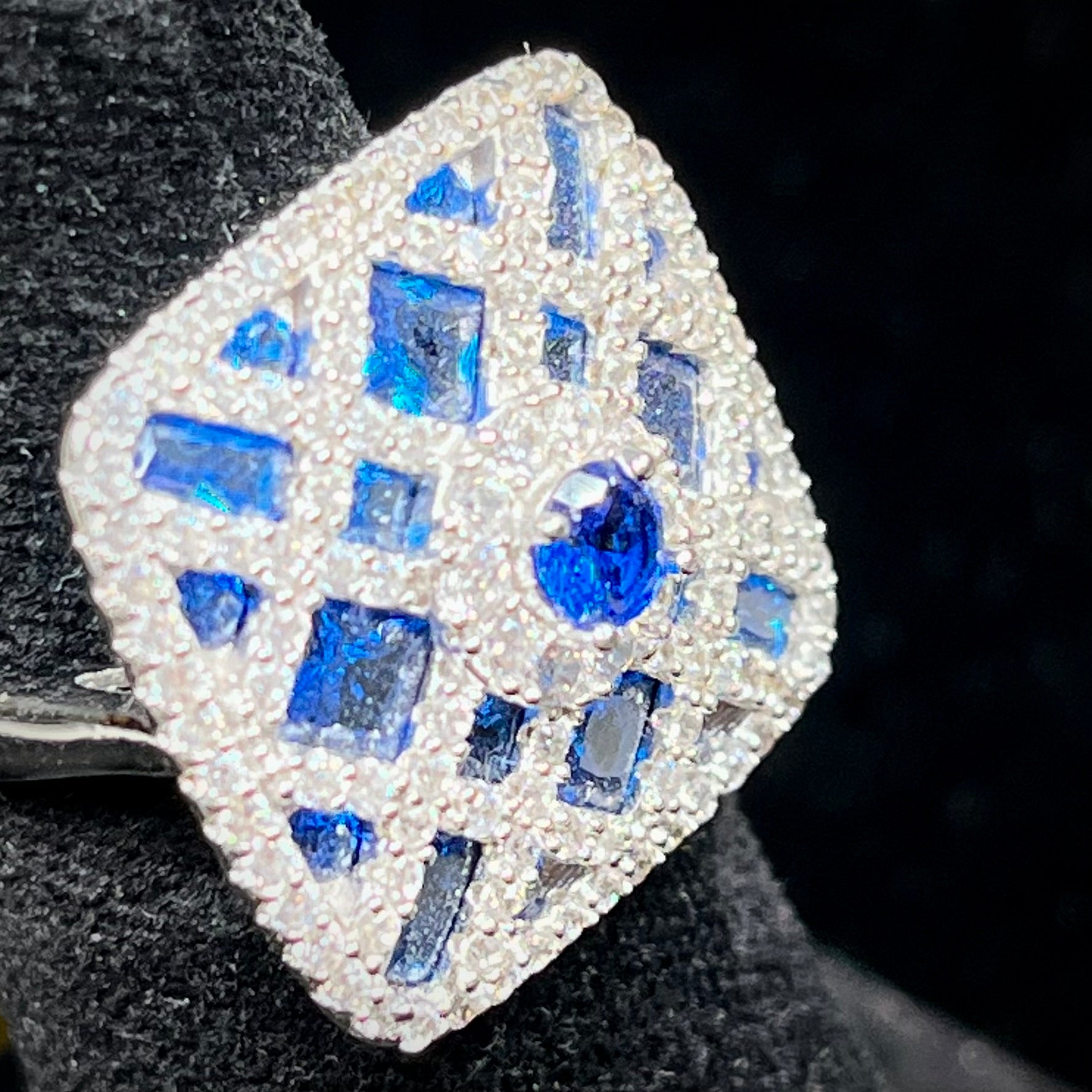 A sterling silver blue and white synthetic stone ring.  The ring strongly resembles a blueberry pie.