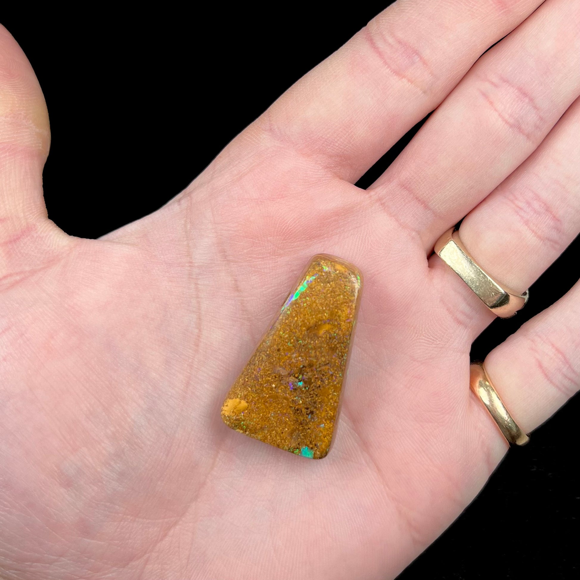 A polished, drilled pipe boulder opal bead.