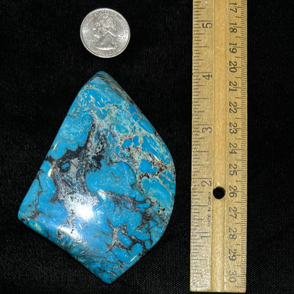 A large polished piece of Kingman turquoise.  The stone is blue with black veining.