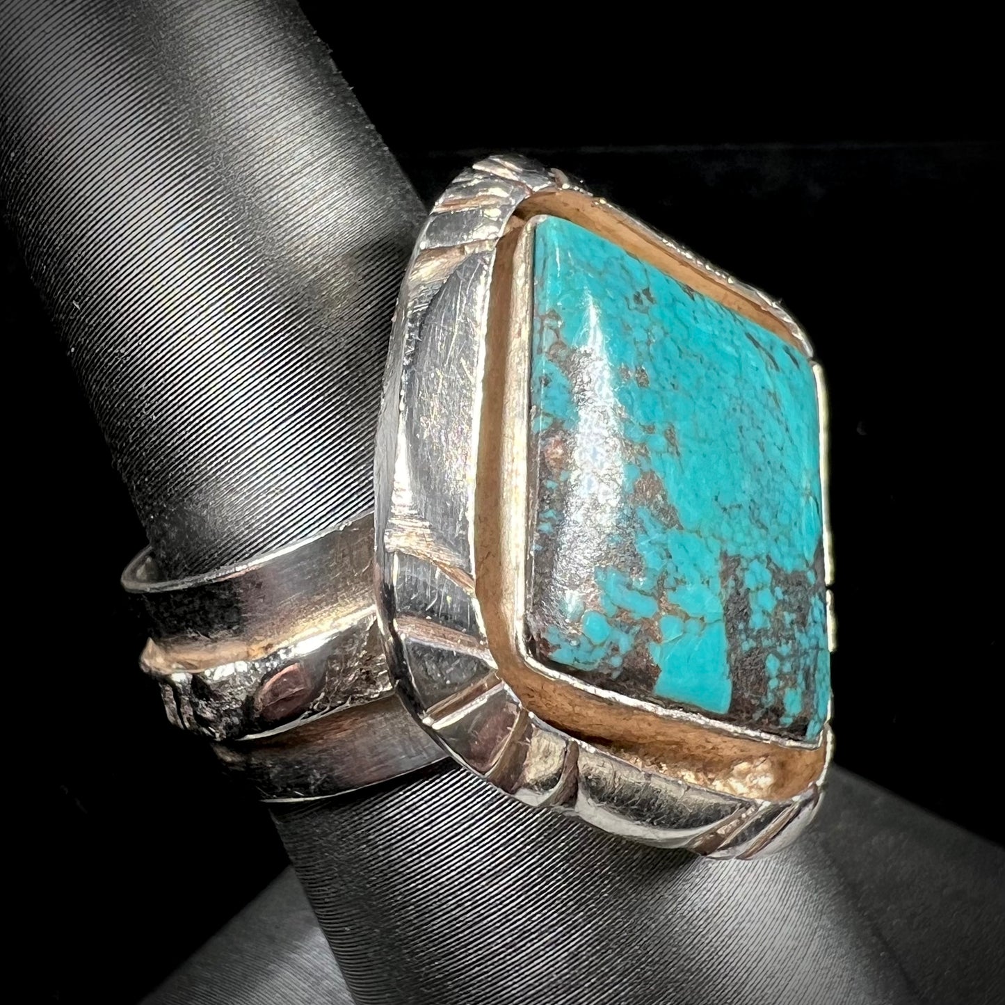 A handmade sterling silver, unisex, likely Navajo ring set with Tibetan turquoise.
