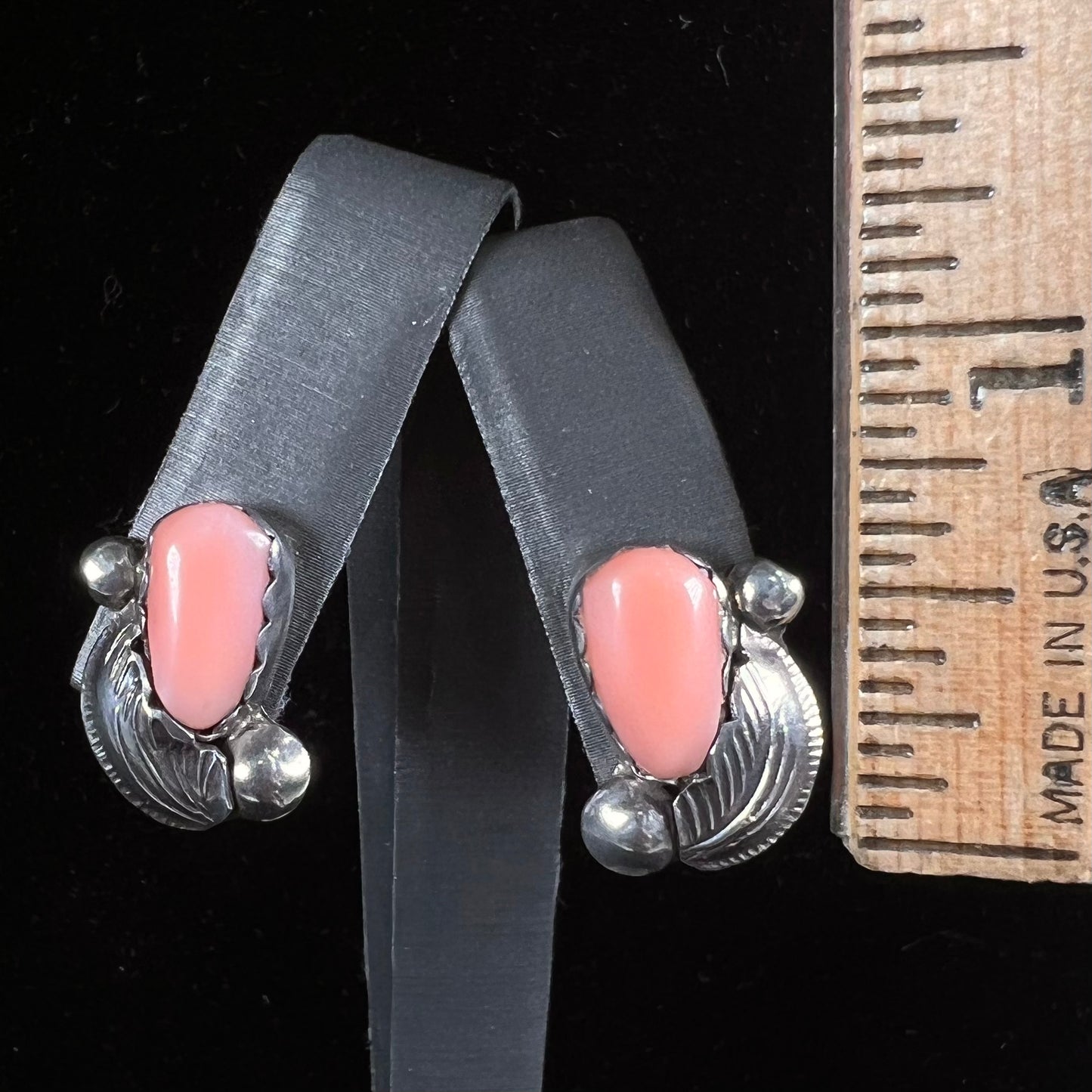 A pair of sterling silver coral earrings handmade by Zuni artists, Carmelita and Dan Simplicio.