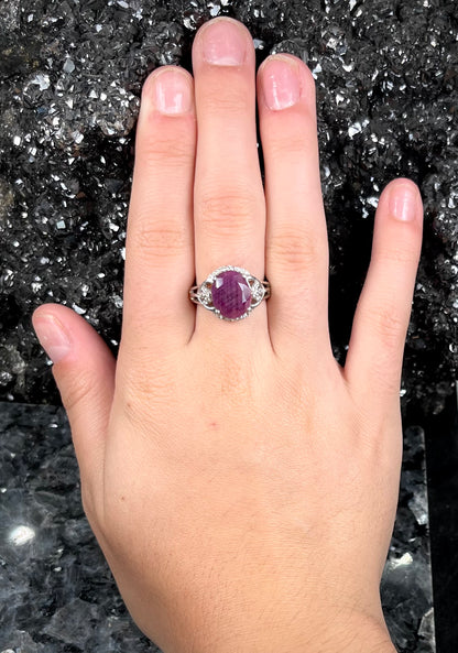 An oval cut natural ruby set in a sterling silver ring.