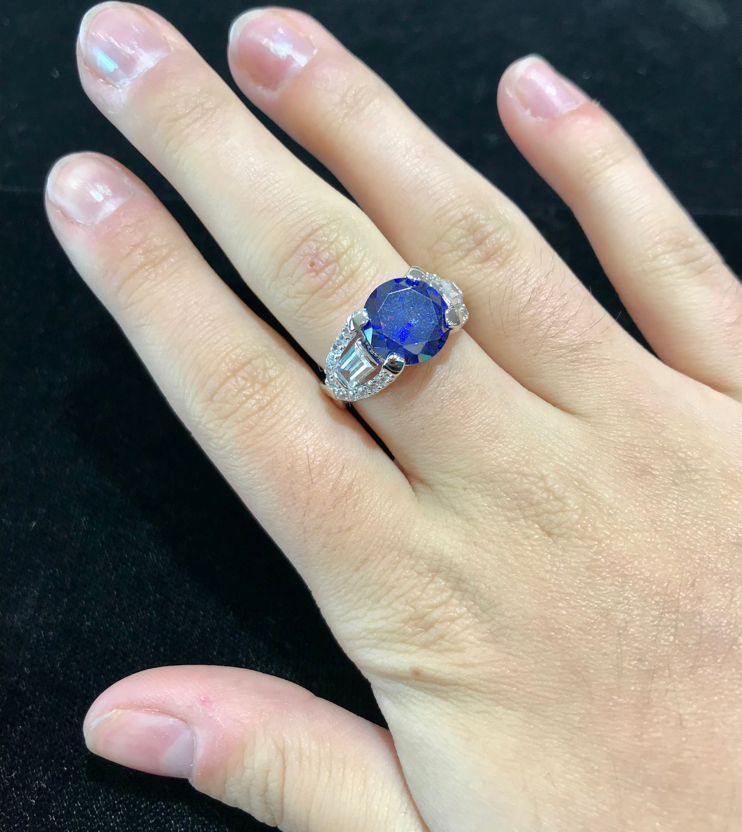 Dark blue synthetic gemstone and cubic zirconia set in sterling silver.