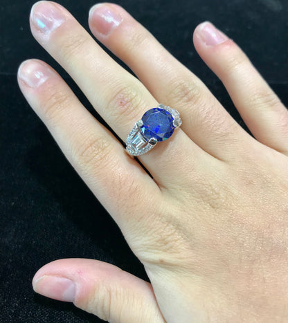 Dark blue synthetic gemstone and cubic zirconia set in sterling silver.