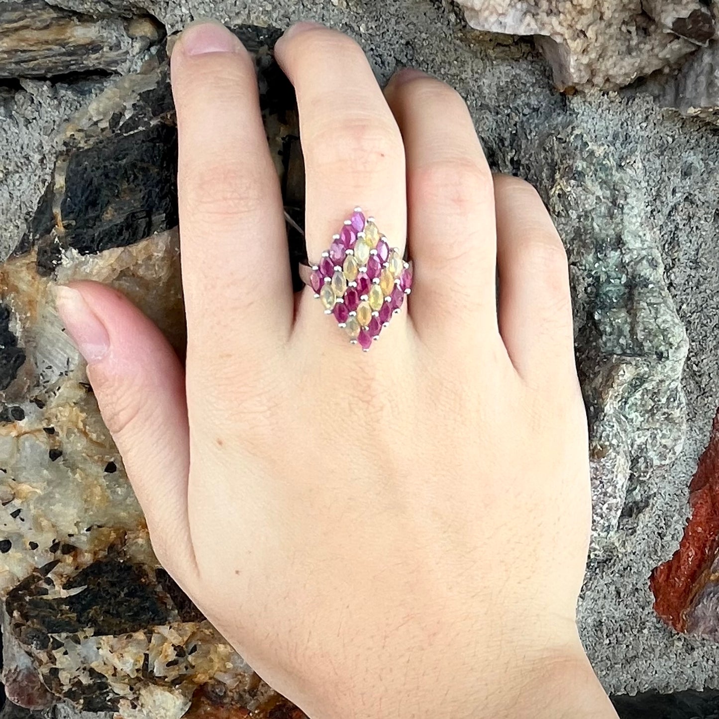 A silver ring set with a cluster of marquise cut rubies and orange Ethiopian fire opals.