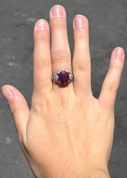An oval cut natural ruby set in a sterling silver ring.