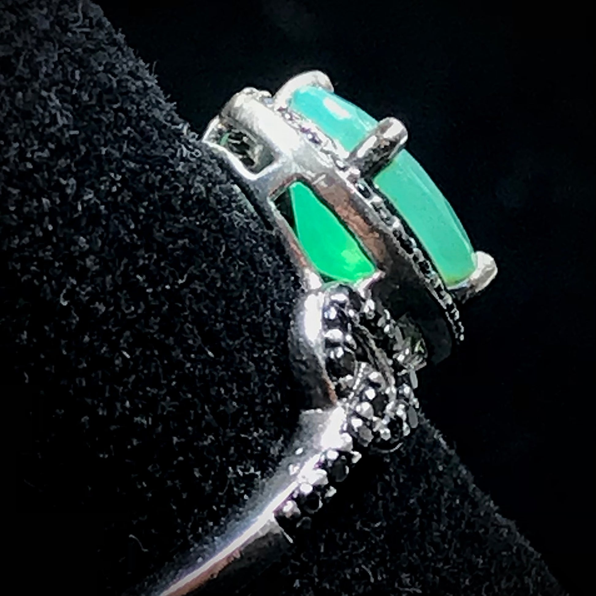 Dyed Ethiopian opal and black spinel prong set into a sterling silver ring.