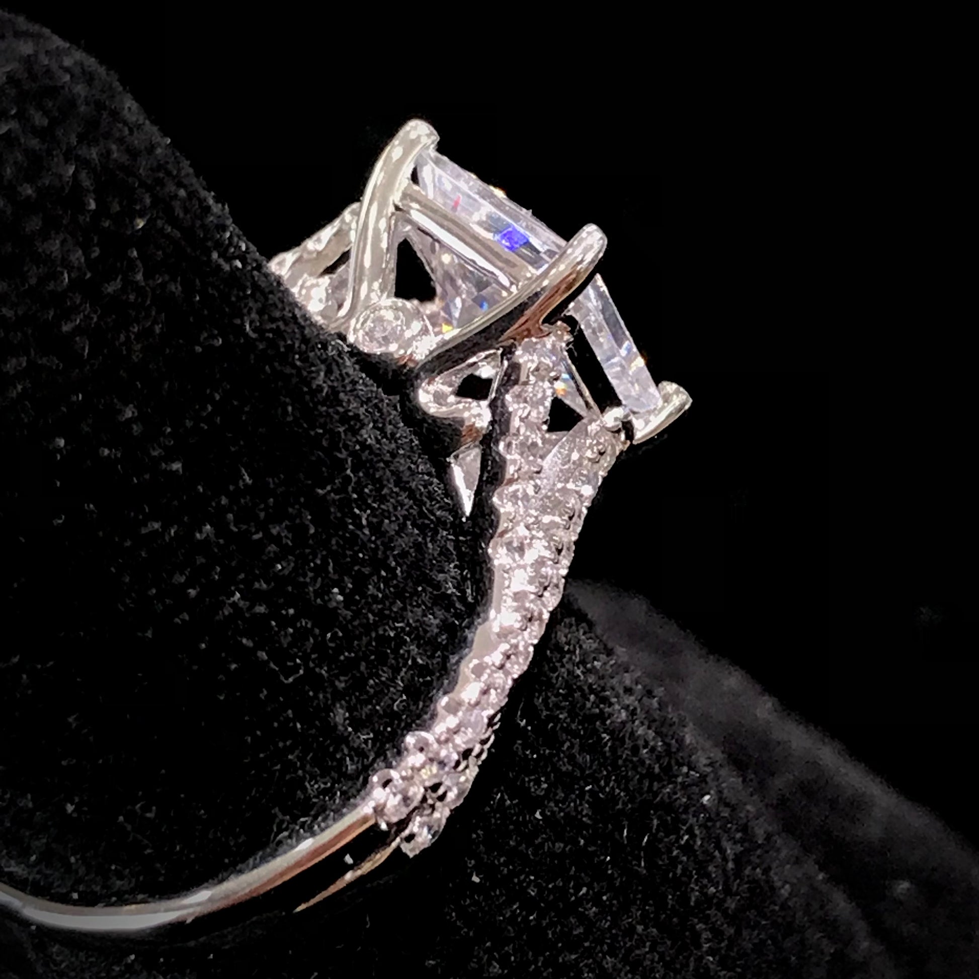 Women's cubic zirconia princess cut ring set in sterling silver with a twisted shank.