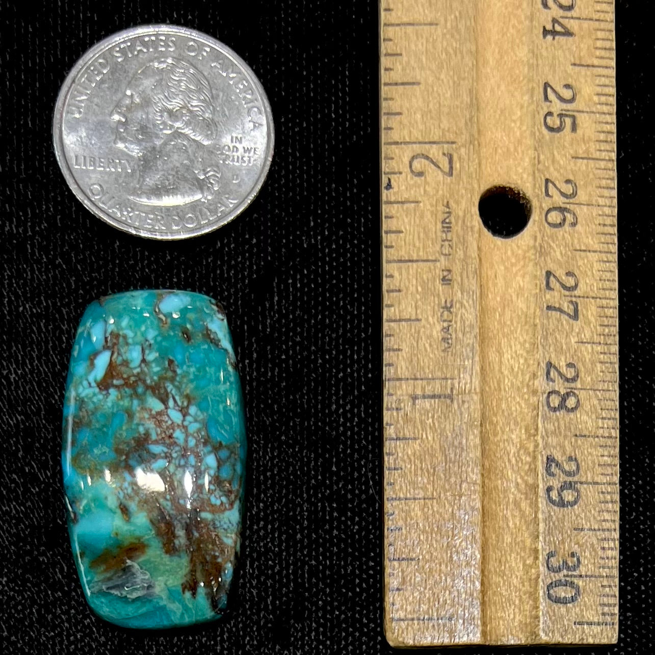 A loose turquoise stone from Royston Mining District, Nevada.  The stone is blue green with brown matrix veining.