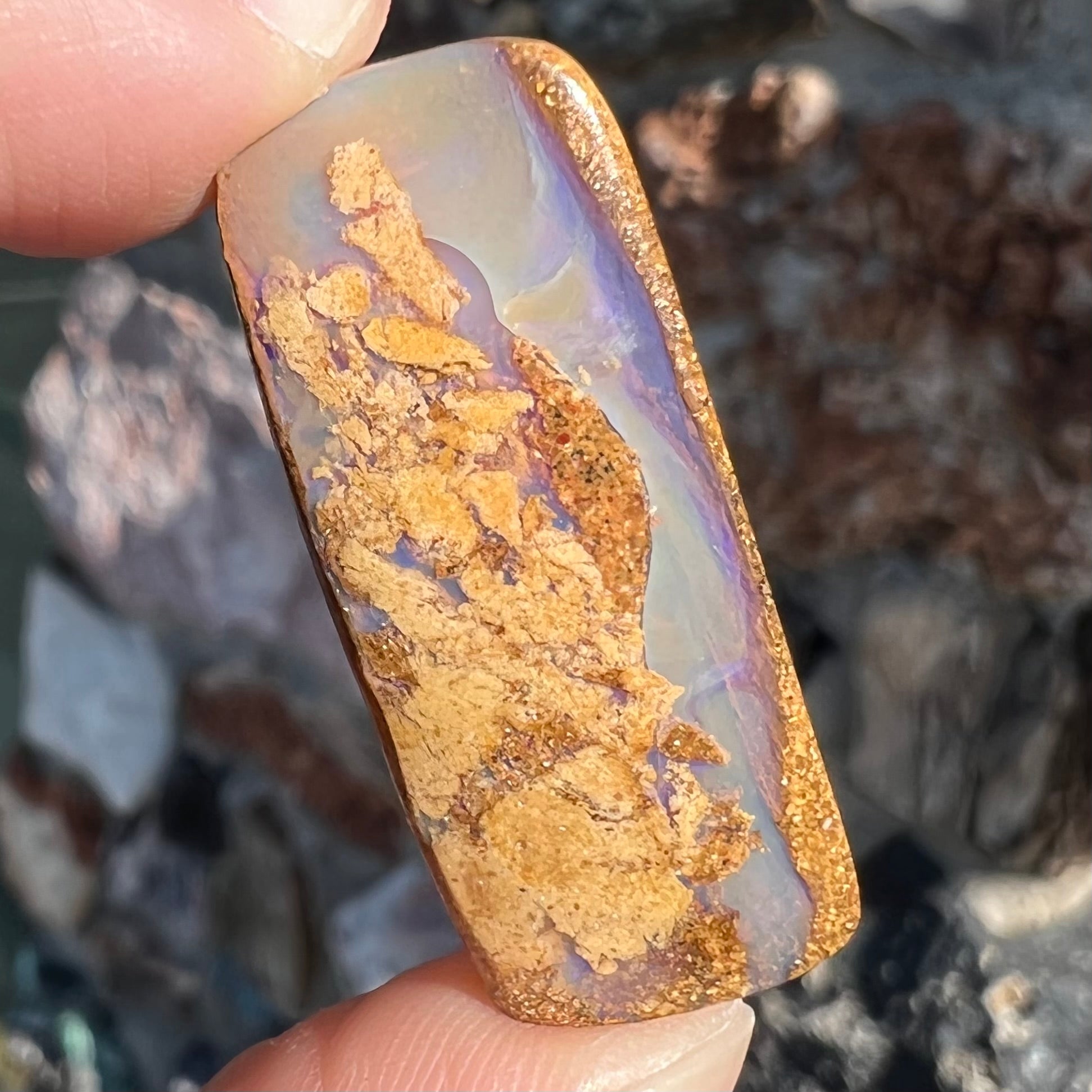 A polished, drilled pipe boulder opal bead.