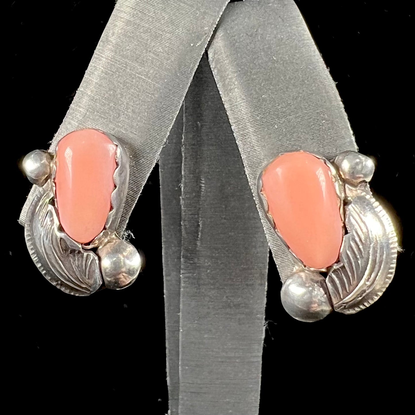 A pair of sterling silver coral earrings handmade by Zuni artists, Carmelita and Dan Simplicio.