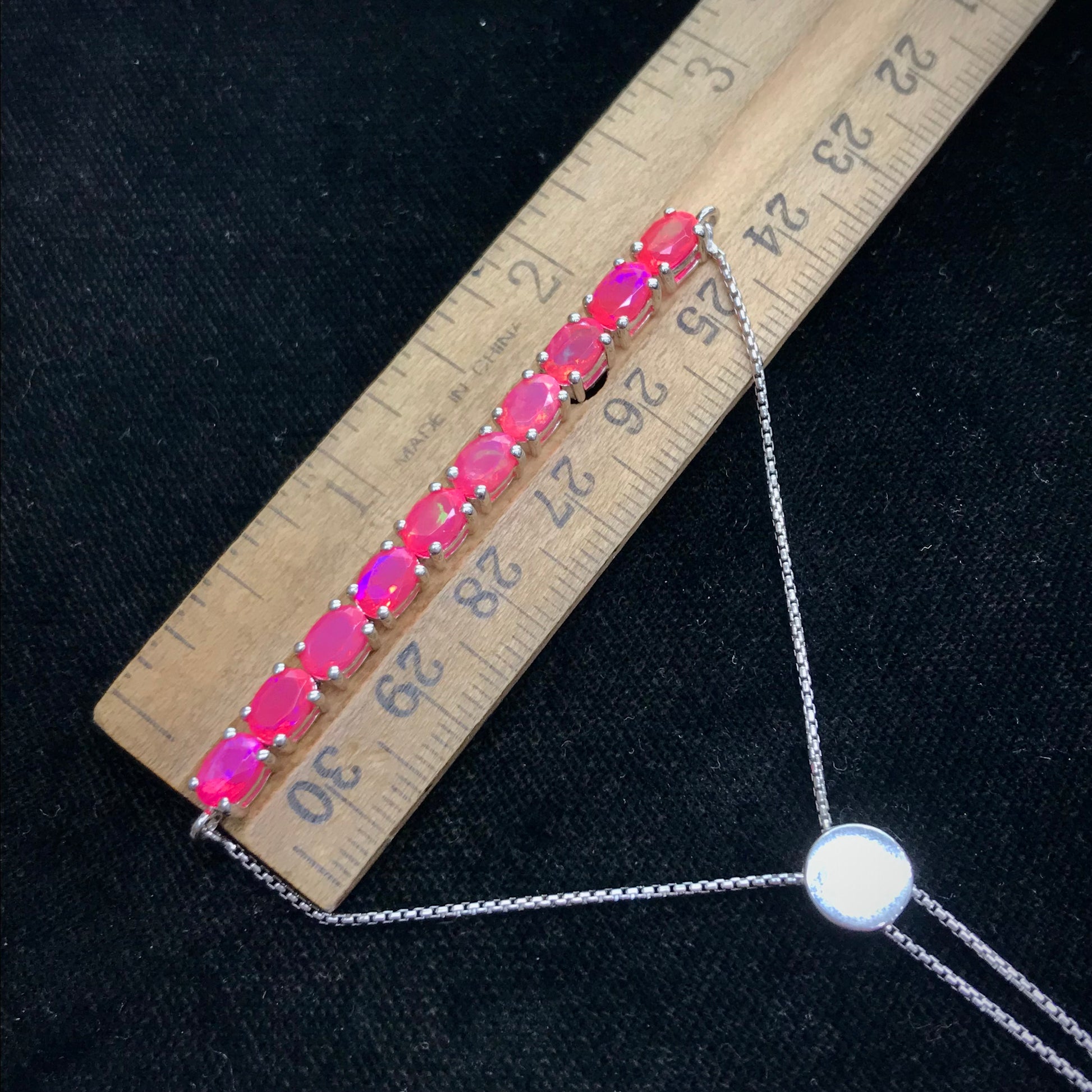 Pink dyed opal adjustable bracelet prong set in sterling silver.