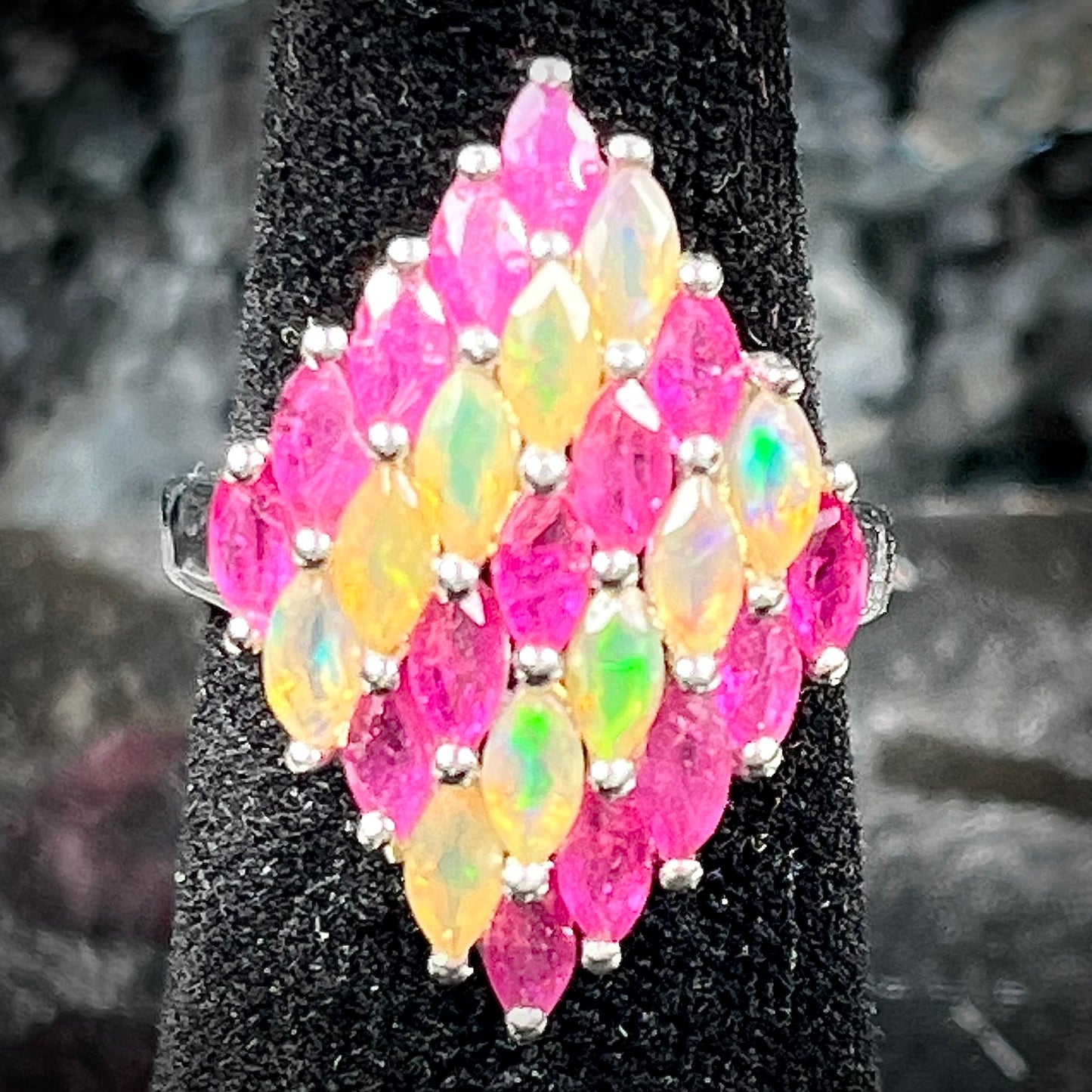 A silver ring set with a cluster of marquise cut rubies and orange Ethiopian fire opals.