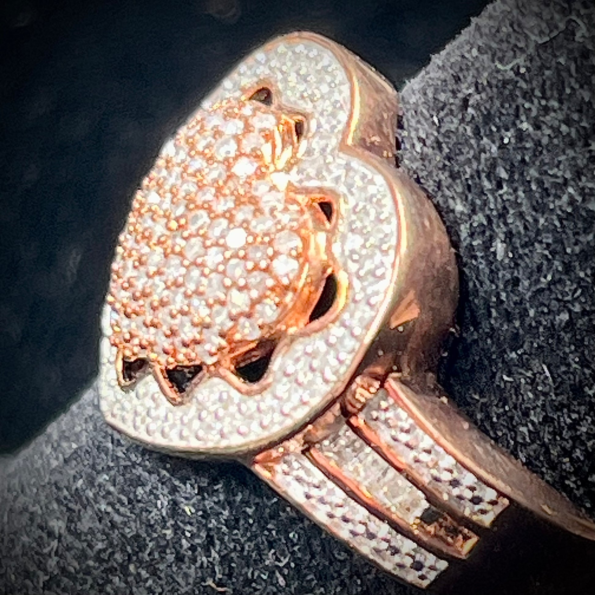 A rose colored metal ring pavé set with round and baguette cut diamonds.