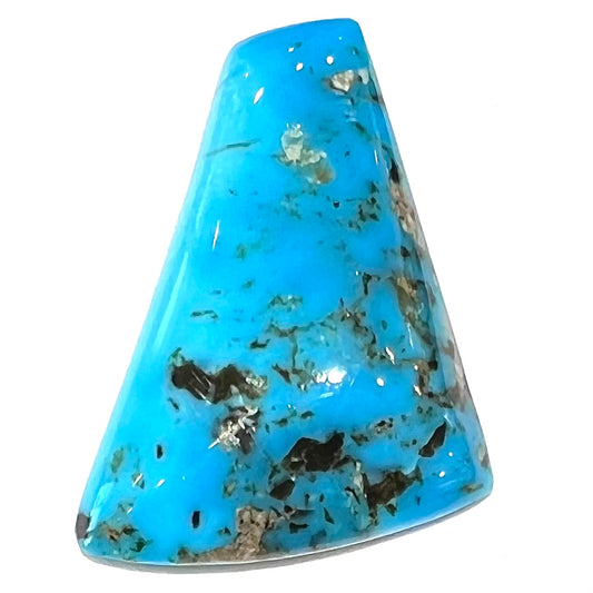 A loose, freeform triangle cabochon cut turquoise stone from the Sleeping Beauty Mine in Arizona.