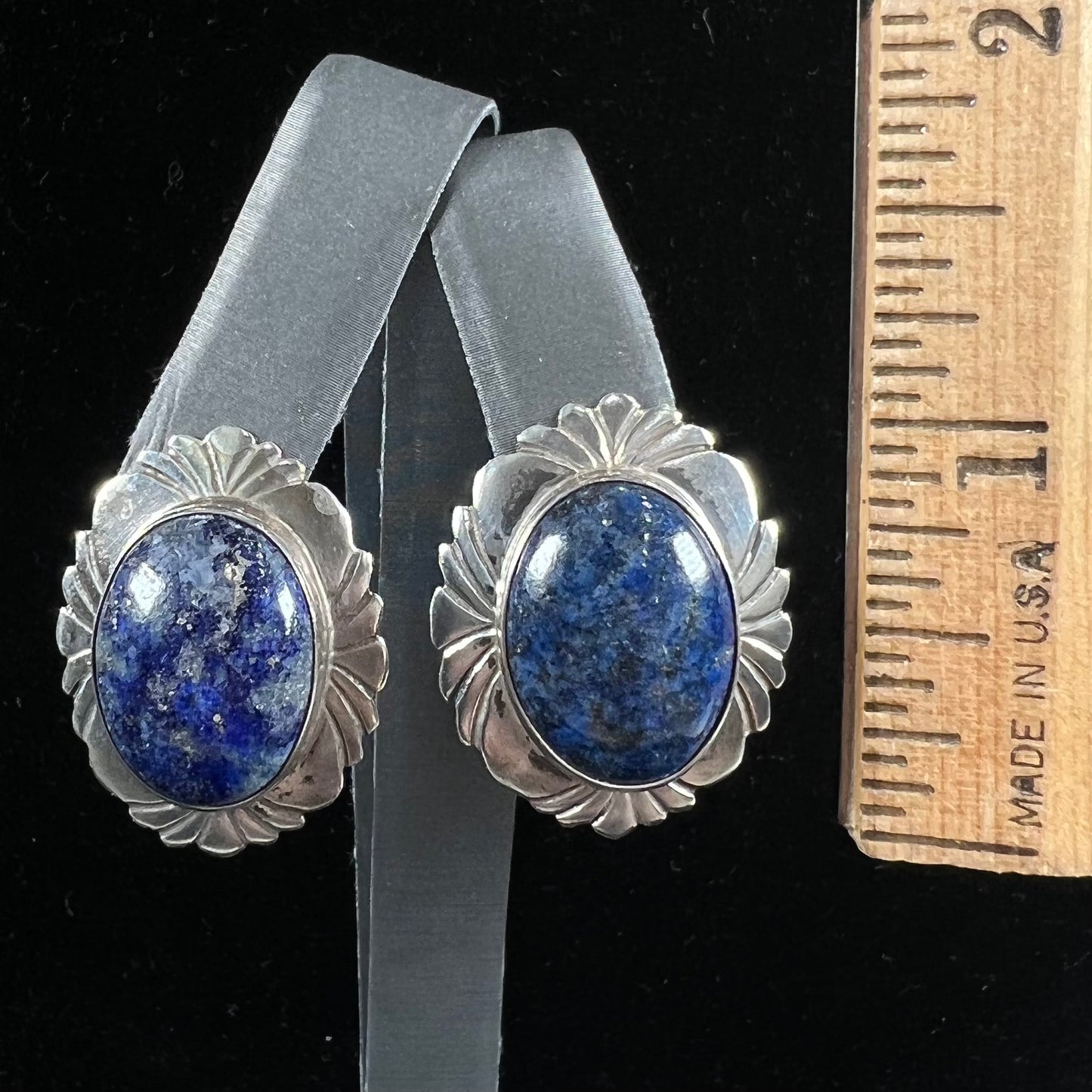 A pair of sterling silver lapis lazuli earrings handmade by Navajo artist, Filbert Brown.