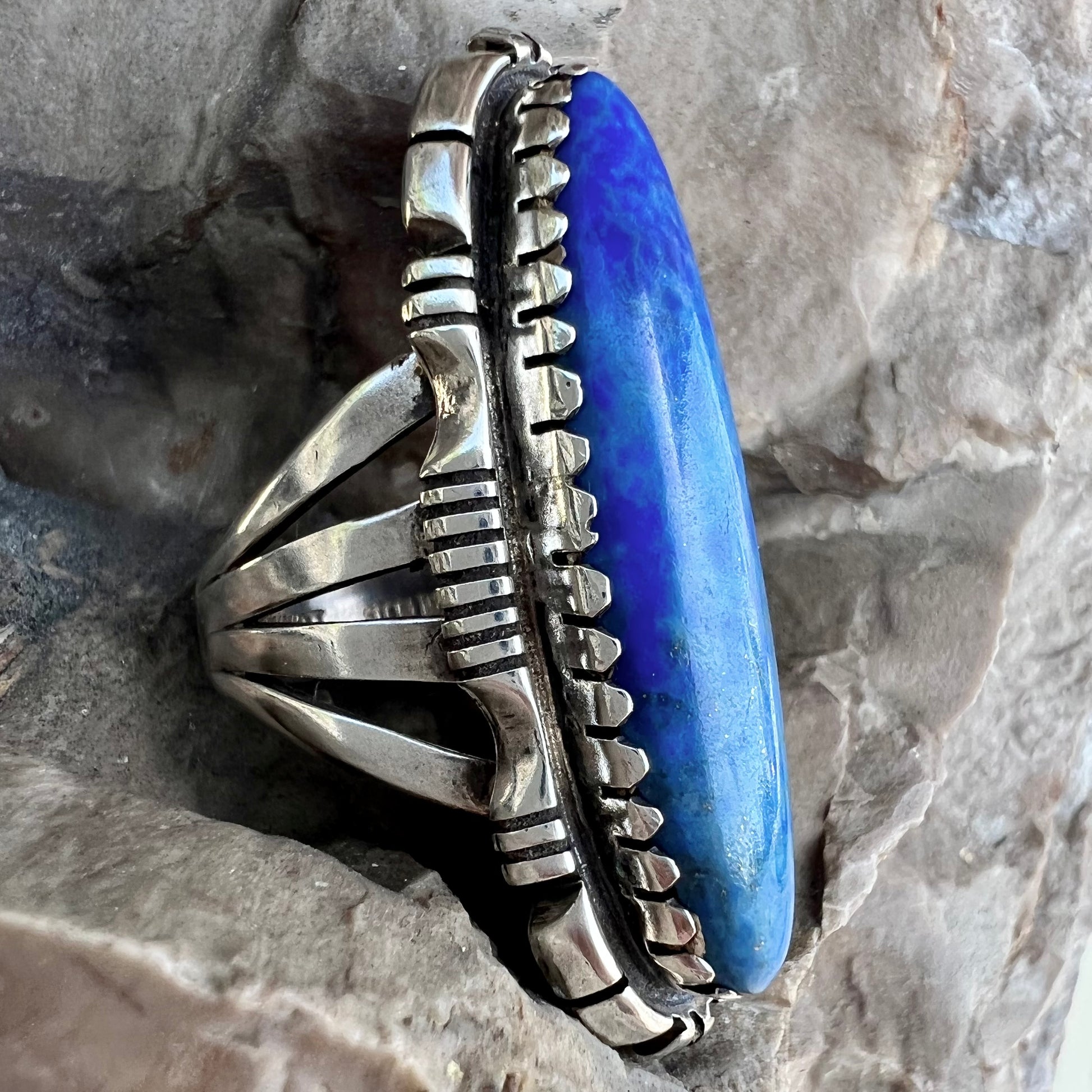 A Navajo style sterling silver lapis lazuli ring engraved with the words "R. Bennett".