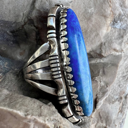A Navajo style sterling silver lapis lazuli ring engraved with the words "R. Bennett".