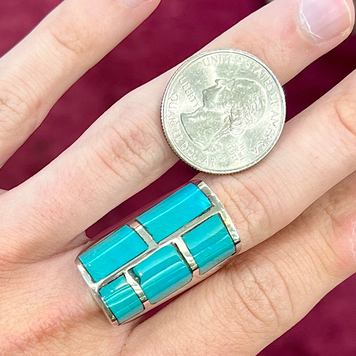 A sterling silver men's ring inlaid with five Royston turquoise stones.