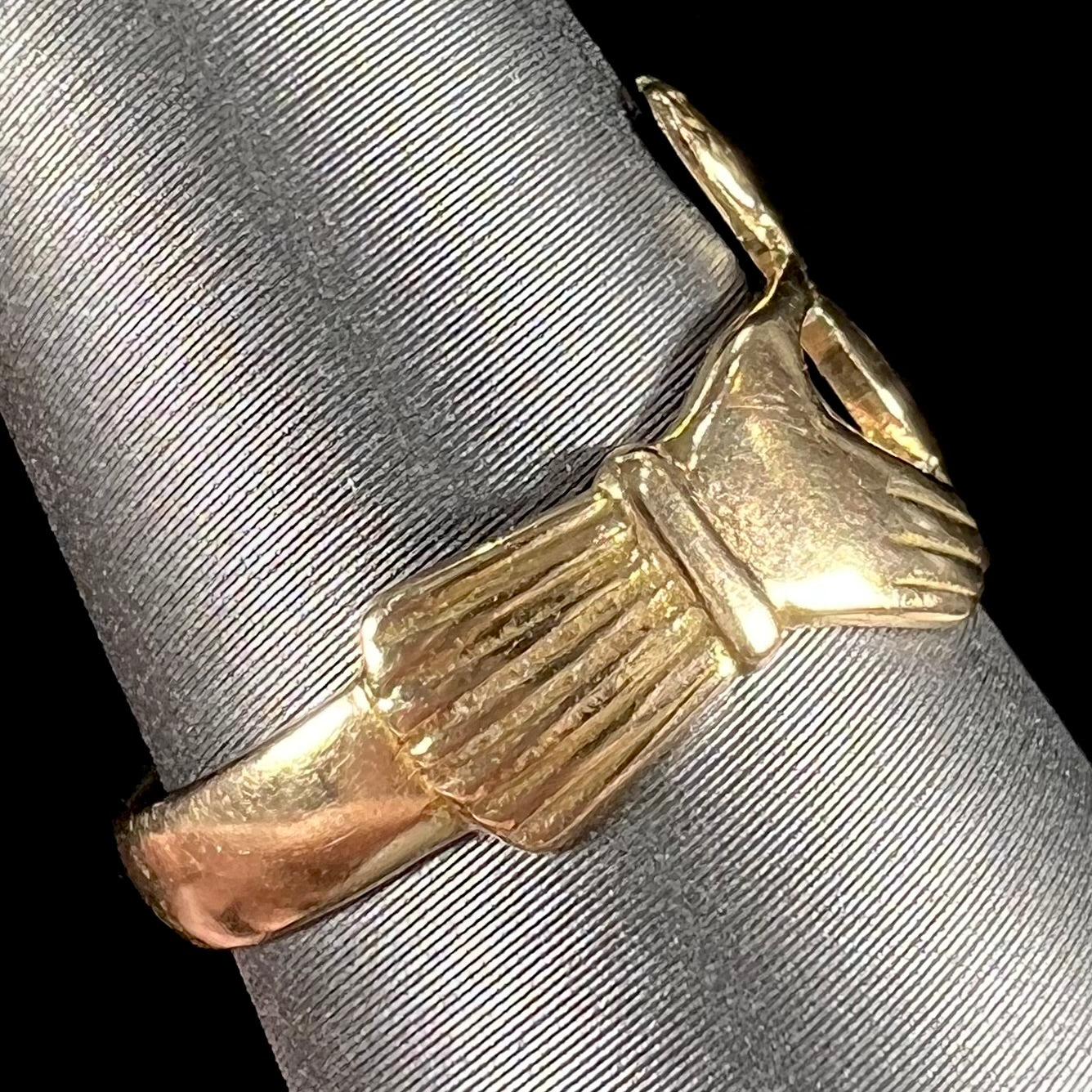 A ladies' 14 karat yellow gold Irish claddagh ring stamped with the maker's hallmarks.