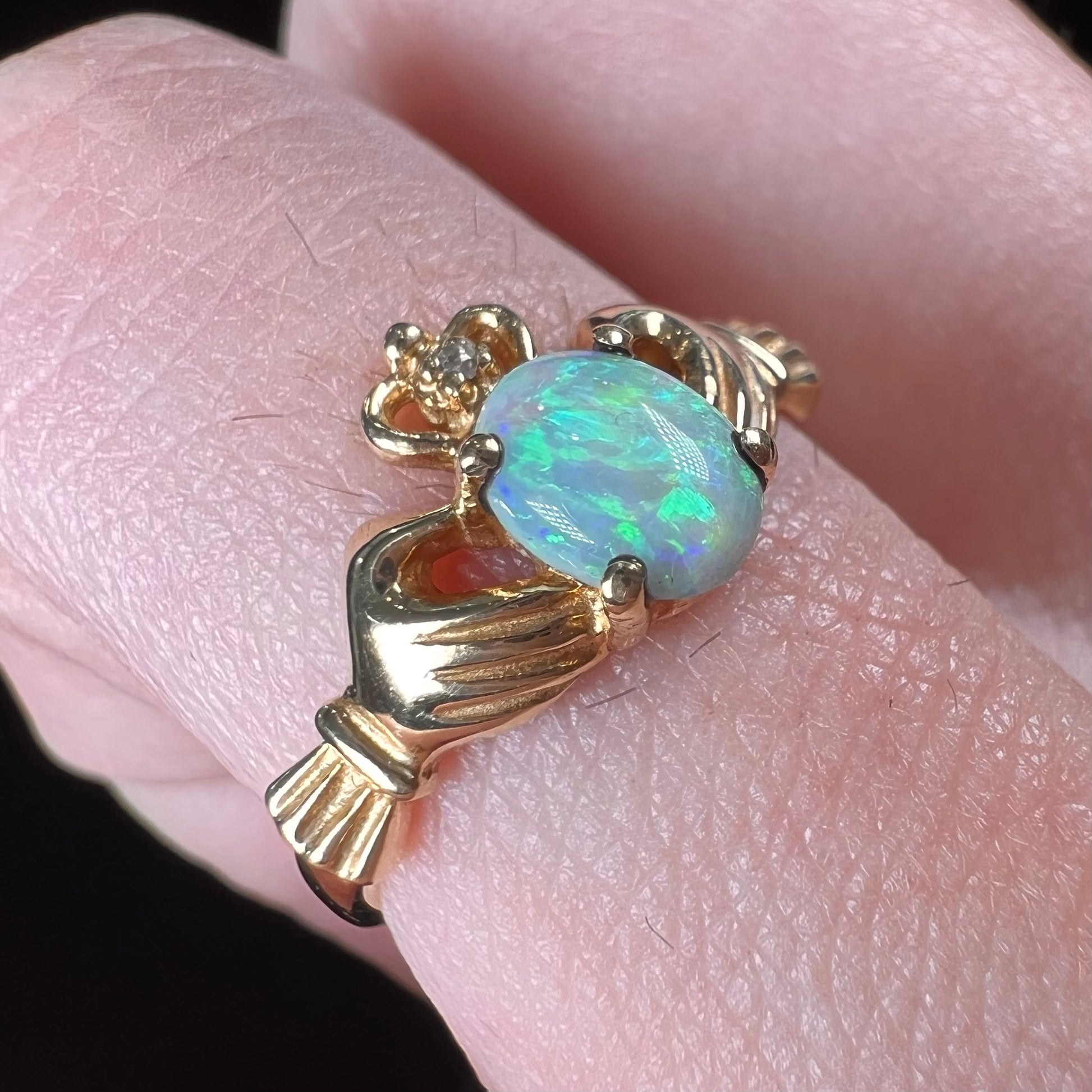 A vintage ladies' yellow gold opal and diamond claddagh ring.