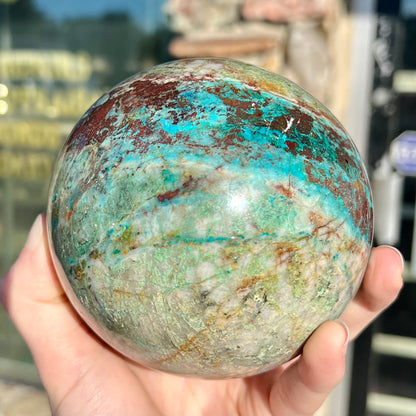 A stone sphere cut from Eilat Stone, mined in Israel.  Material contains turquoise, chrysocolla, azurite, malachite, and cuprite.