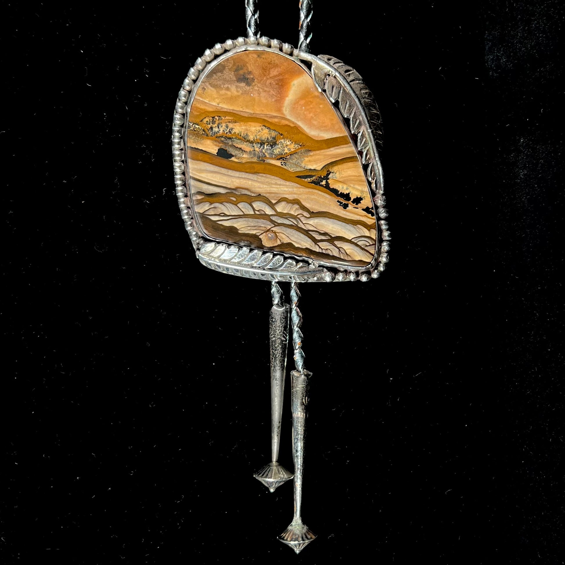 A men's sterling silver bolo tie set with a Biggs picture jasper stone.