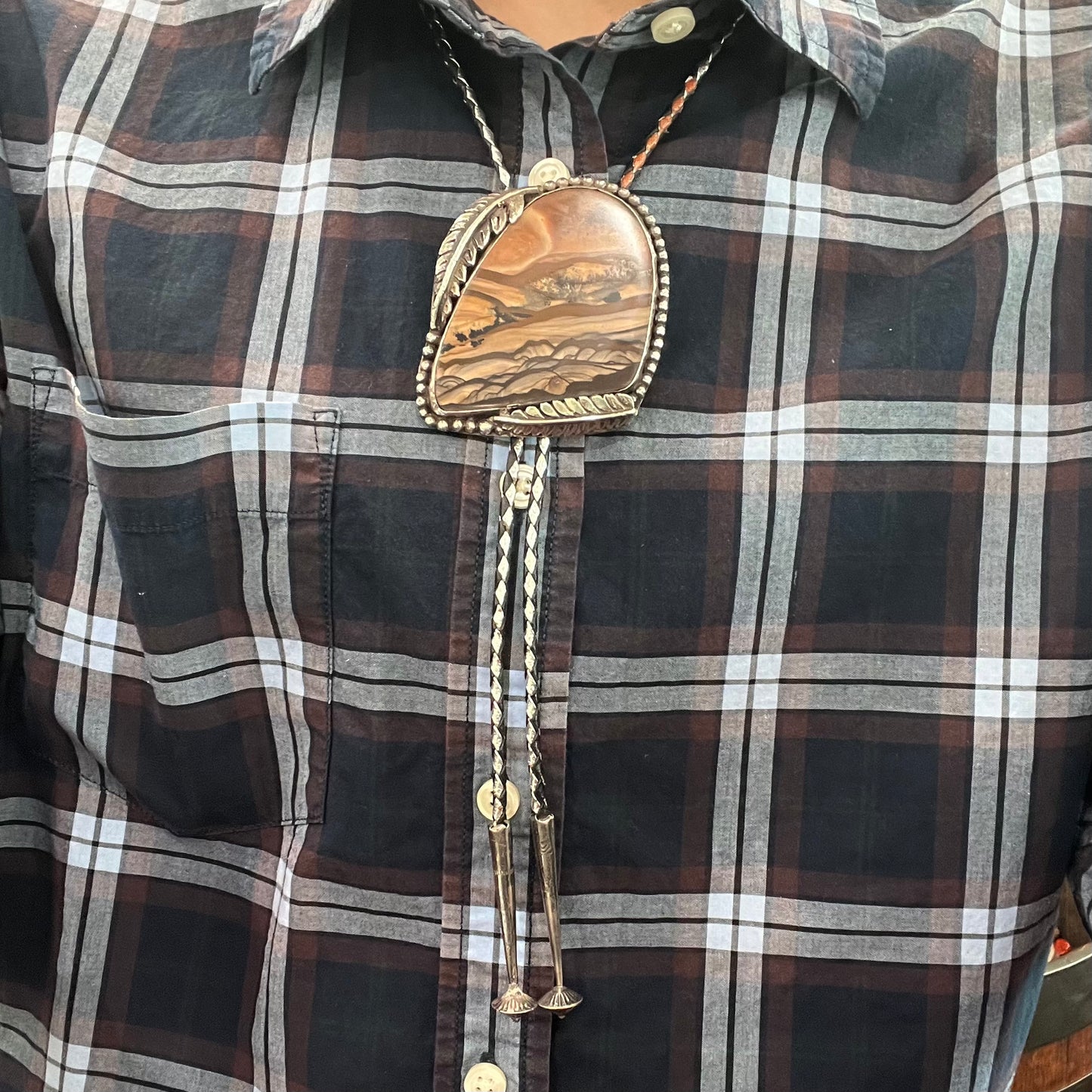 A men's sterling silver bolo tie set with a Biggs picture jasper stone.