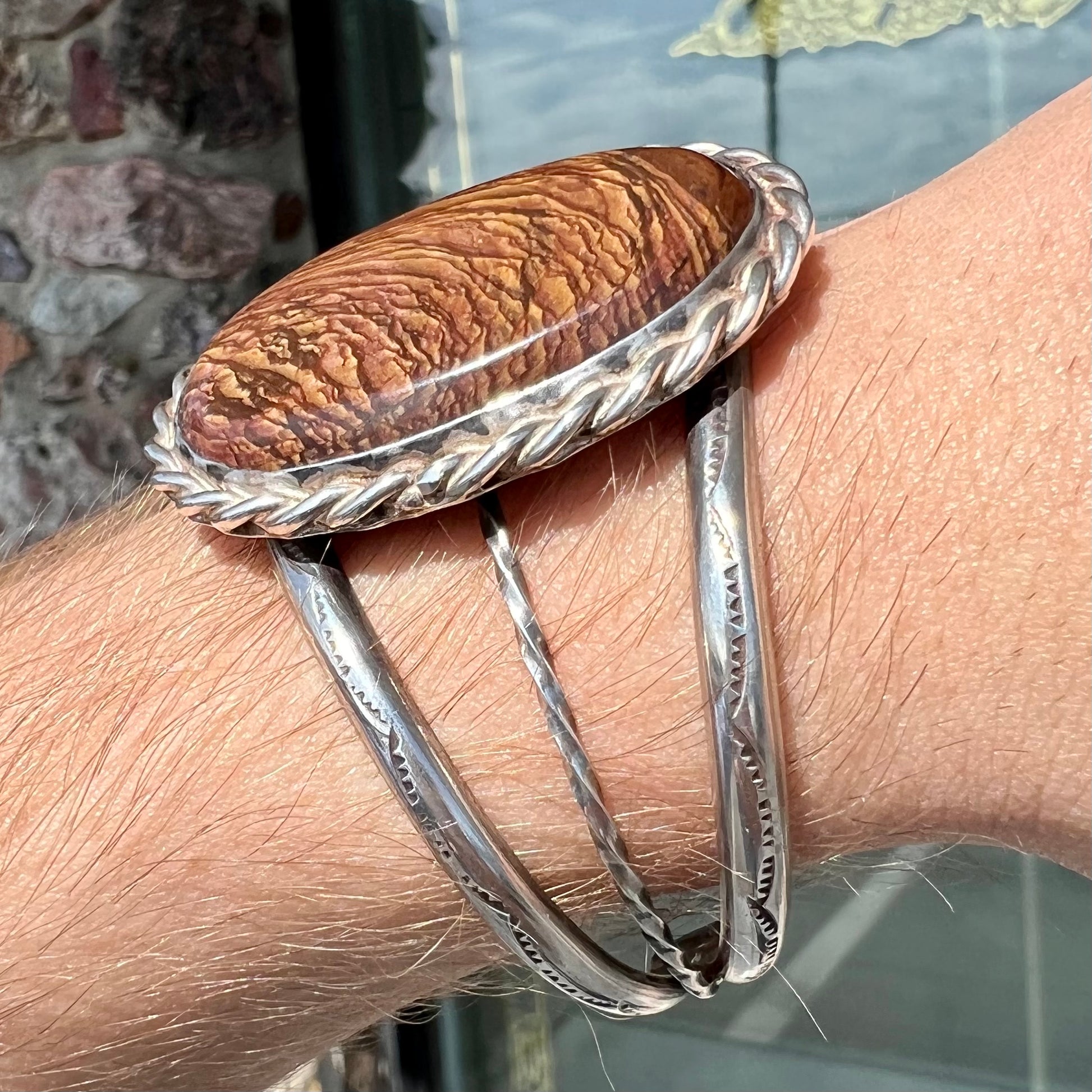 A sterling silver rope bezel set picture jasper cuff bracelet.