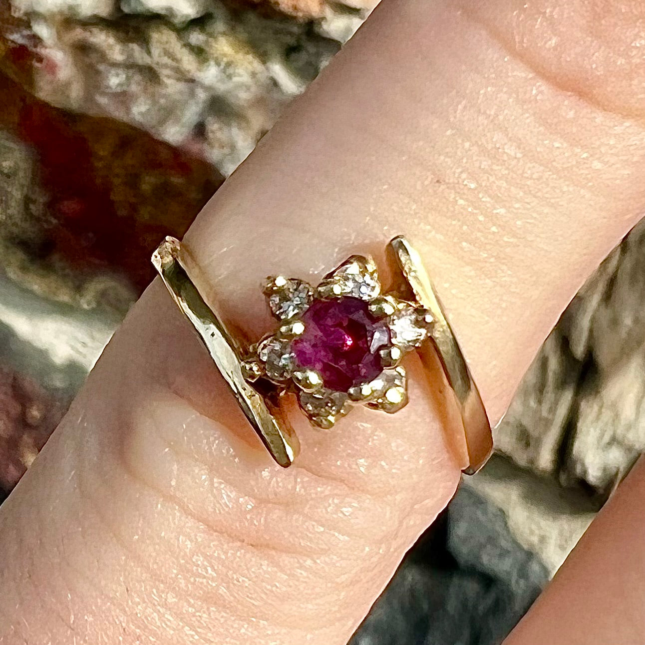 Custom twisted shank ruby and diamond halo yellow gold ring.