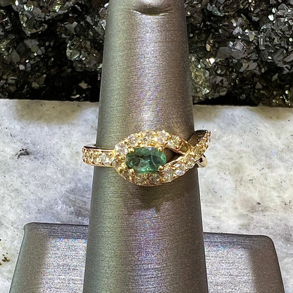 Yellow gold alexandrite and pave set diamond ladies' ring on ring stand.