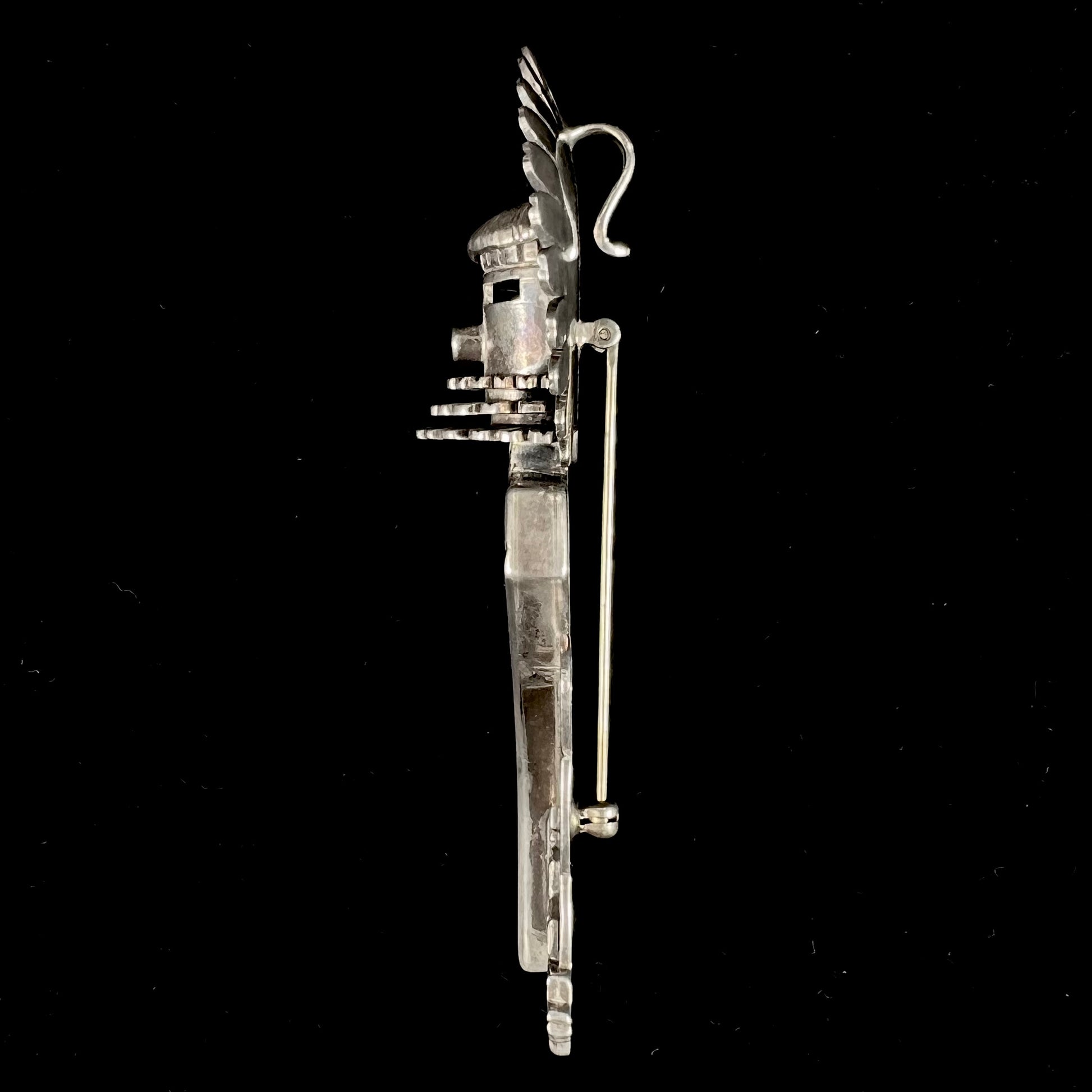 A Morning Singer kachina doll pendant made from sterling silver by Navajo artist Bennie Ration.